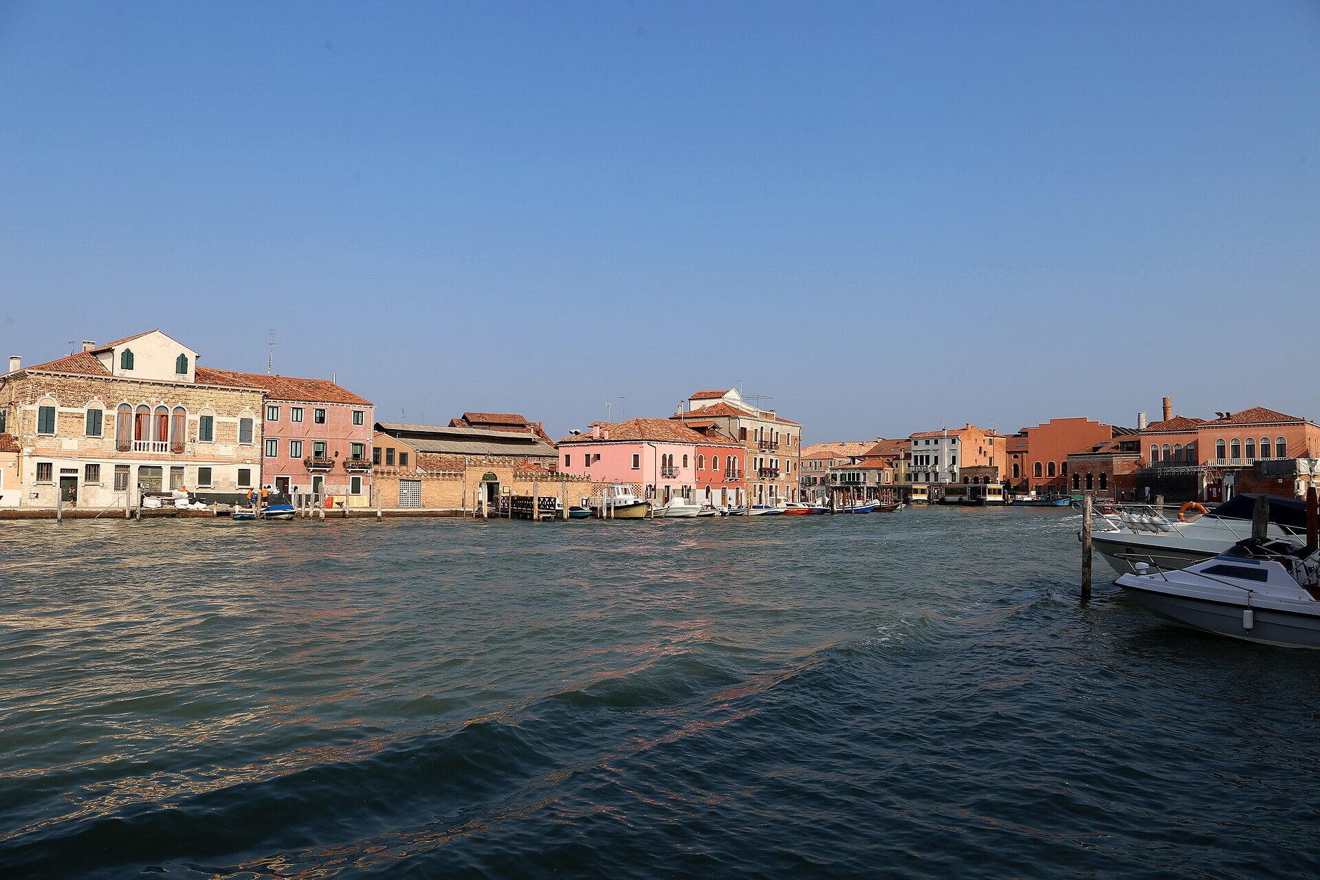 A canal on Murano lined with brick houses